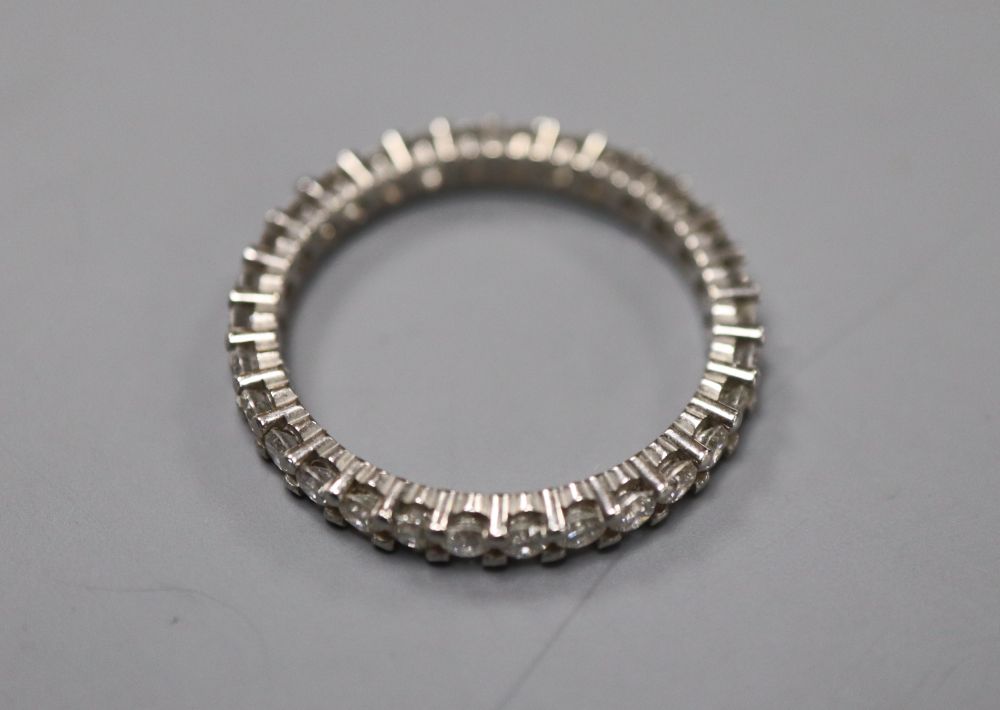 A platinum and diamond full eternity ring, claw-set with small round diamonds, size N, gross 2.8 grams.